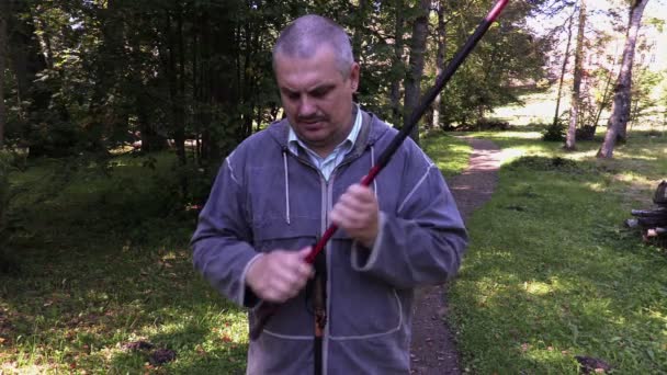 Hiker memperbaiki tongkat jalan — Stok Video
