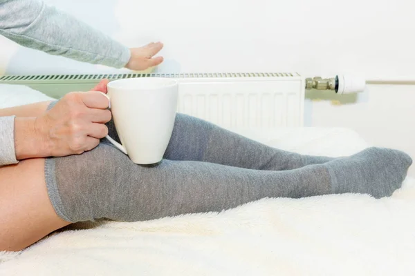 Woman Warming Tea Cup Holding Hand Heating Radiator — Stock Photo, Image