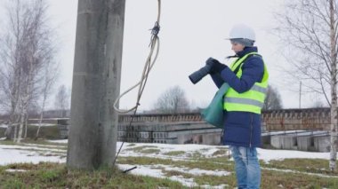 İnşaat alanında fotoğraf makinesi kullanan kadın inşaat mühendisi.