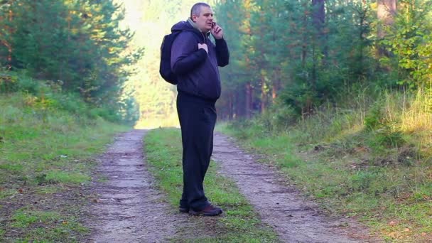 Caminhante com telefone celular na floresta em trilha — Vídeo de Stock