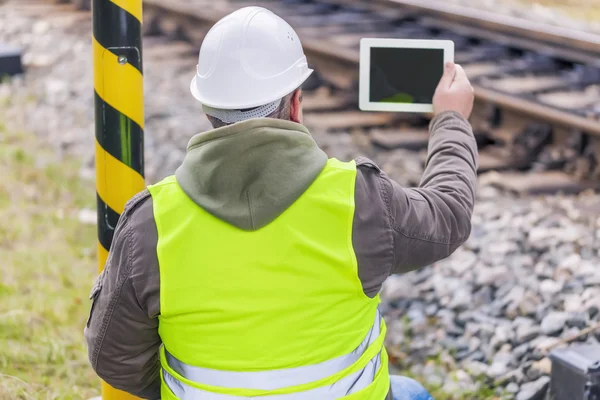 Engineer filmed the railway with tablet PC — Stock Photo, Image