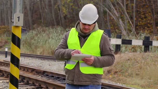 Railway engineer on rails working with tablet PC — Stock Video