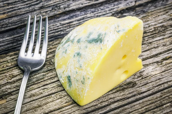 Moldy cheese on wooden boards — Stock Photo, Image