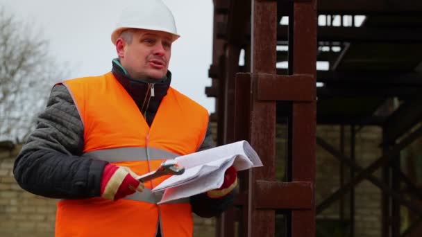 Angry foreman with documents and adjustable wrench in factory — Stock Video