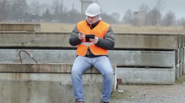 Cep telefonu ile mühendis ve tablet Pc üzerinde beton paneller