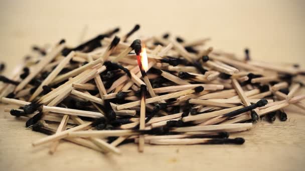 Burnt matches stack with burning match — Stock Video