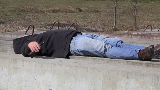 Drunk men sleeping near bottle of alcohol — Stock Video