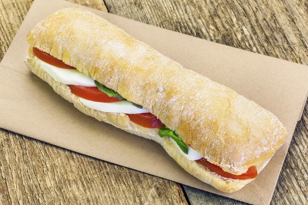 Filled baguette with mozzarella cheese — Stockfoto