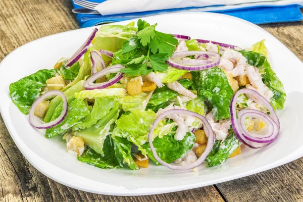 Caesar salad with shrimp on plate