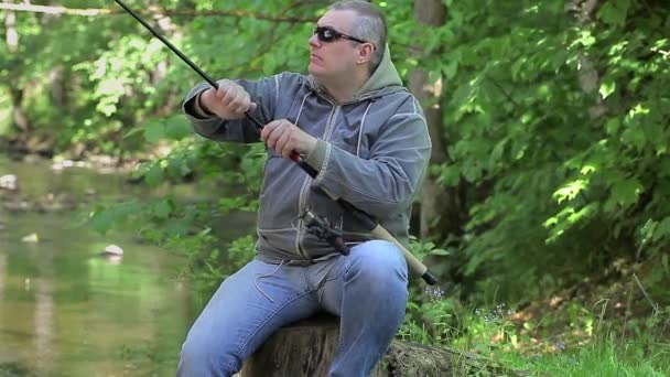 Man with fishing rod at the river — Stock Video