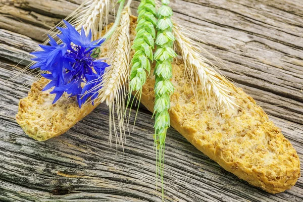 Toasts with with cereal and cornflower on wood — Stock Photo, Image