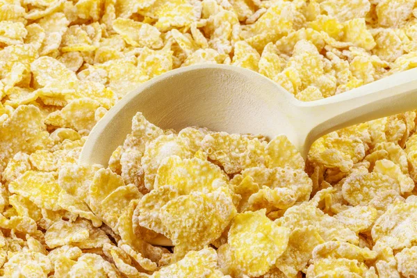 Cornflakes with wooden spoon Royalty Free Stock Photos