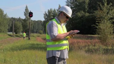 Demiryolu mühendis demiryolu sinyal işaretleri yakınındaki Tablet Pc kullanma