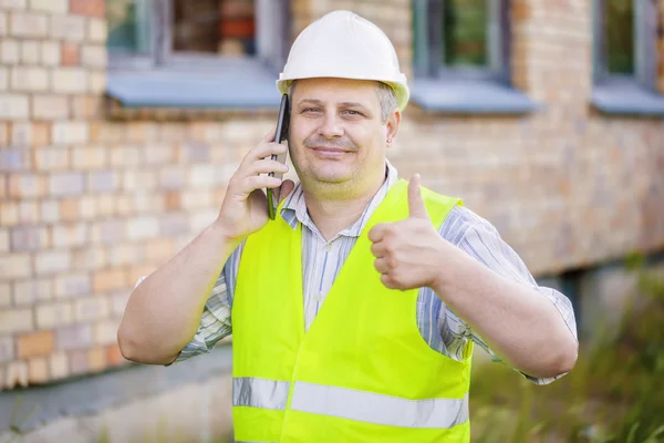 Engineer showing thumb up near the building — Stock Photo, Image