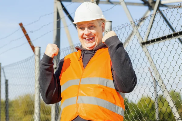 Happy worker at outdoors near the fence — Stock Photo, Image