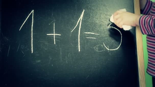 Little girl trying to clear math task from the blackboard — Stock Video