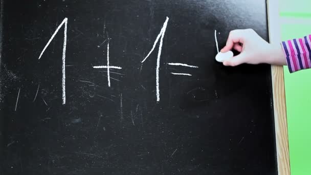 Little girl try to write number on blackboard — Stock Video