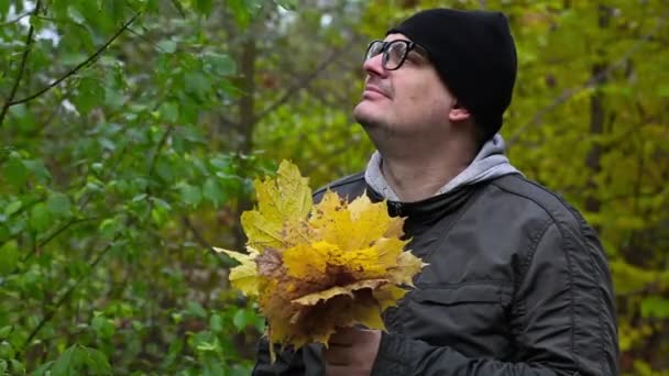 Man with autumn day leaves — Stock Video