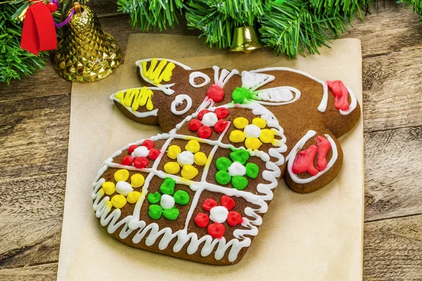 Christmas gingerbreads on paper on the table — Stock Photo, Image