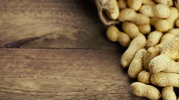 Peanuts in shell on jute fabric bag — Stock Video