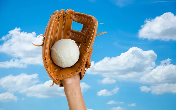 children hand for catcing softball with glove on blue sky  blue sky