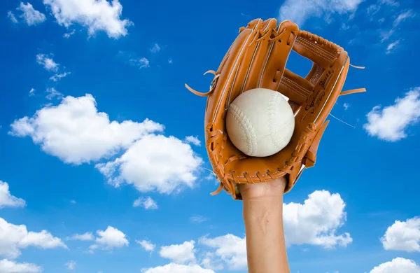 children hand for catcing softball with glove on blue sky