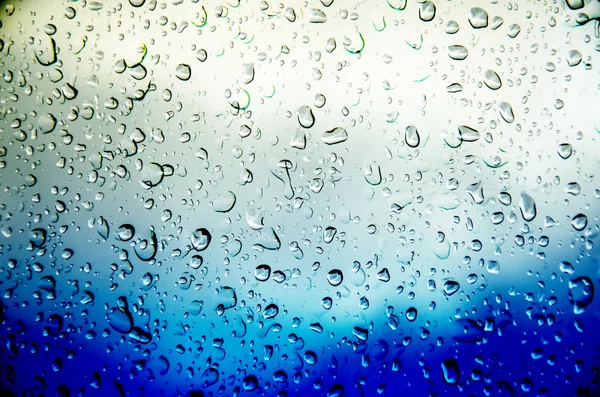 Fondo azul con agua de gota —  Fotos de Stock