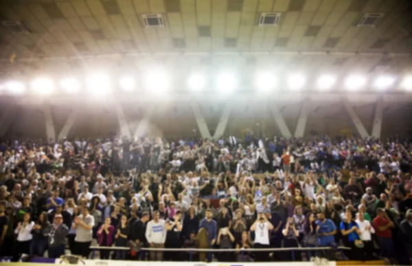 Blurred background of crowd of people in a basketball court