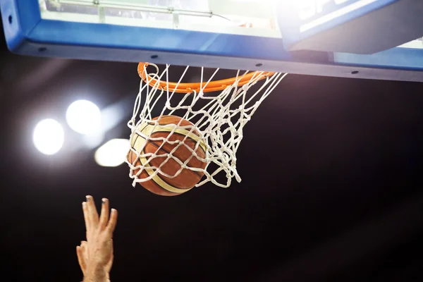 Basketbol bir spor sahasında çemberin içinden geçiyor — Stok fotoğraf