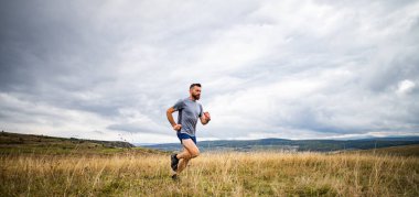 Doğada koşan yakışıklı bir iz koşucusu