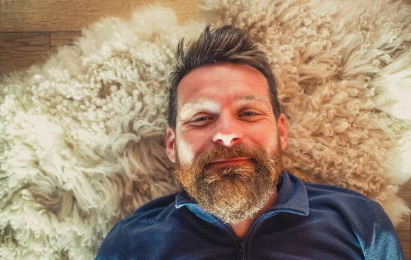 Portrait Happy Relaxed Man Laying Sheepskin Rug — Stock Photo, Image