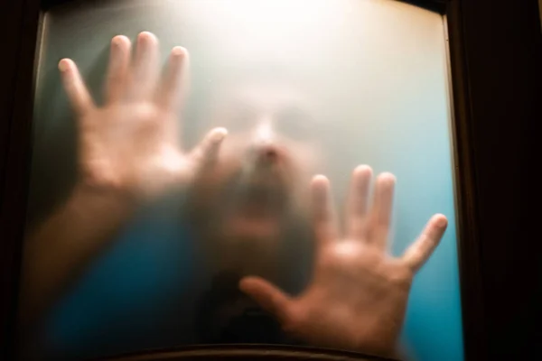 scary picture of hands behind glass