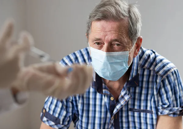 elderly man getting coronavirus vaccine