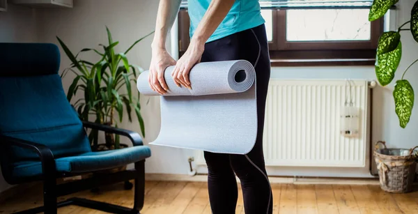 Woman Folding Yoga Mat Home — Stock Photo, Image