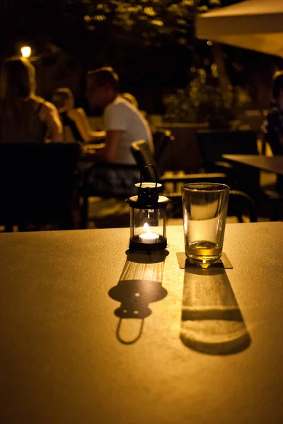 empty glass on a restaurant table at night