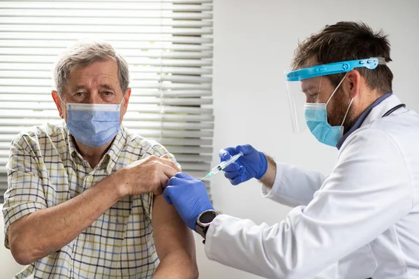 elderly man getting coronavirus vaccine