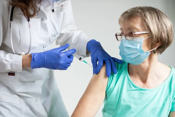 elderly woman getting coronavirus vaccine