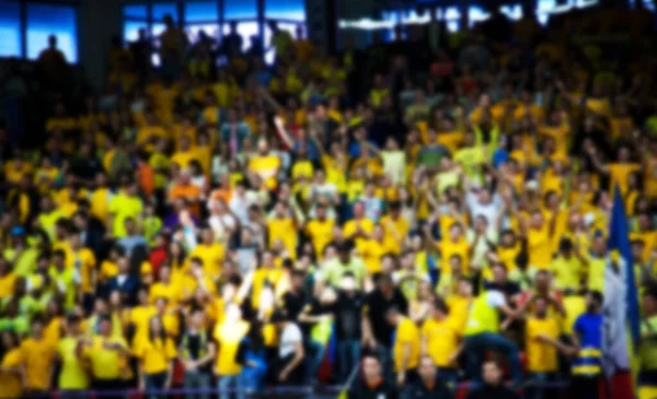 Blurred background of crowd of people in a basketball court