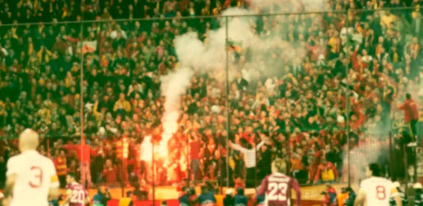 crowd of soccer fans at the stadium - defocused background - football concept