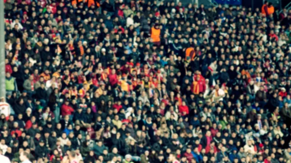 crowd of soccer fans at the stadium - defocused background - football concept