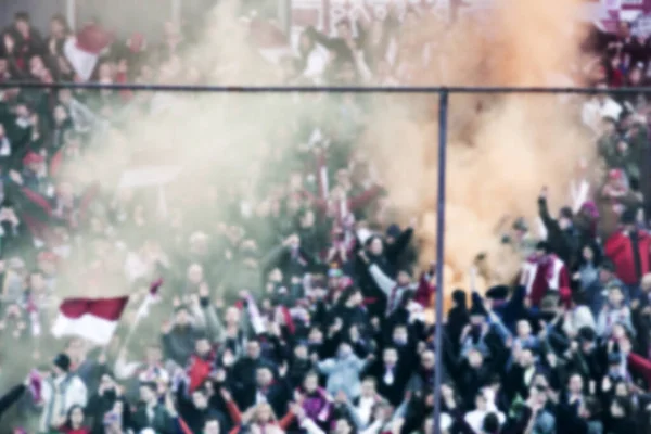 crowd of soccer fans at the stadium - defocused background - football concept