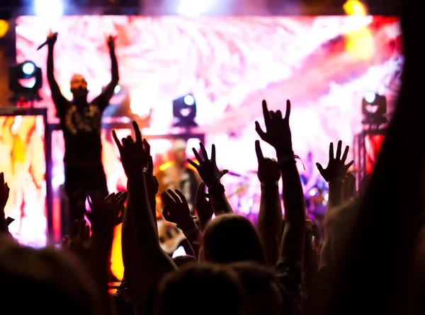 crowd with raised hands at concert - summer music festival