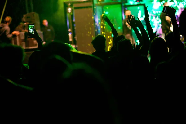 crowd with raised hands at concert - summer music festival