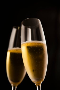 Champagne glasses against dark background 