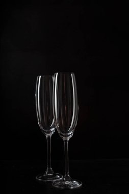 empty Champagne glasses against dark background 