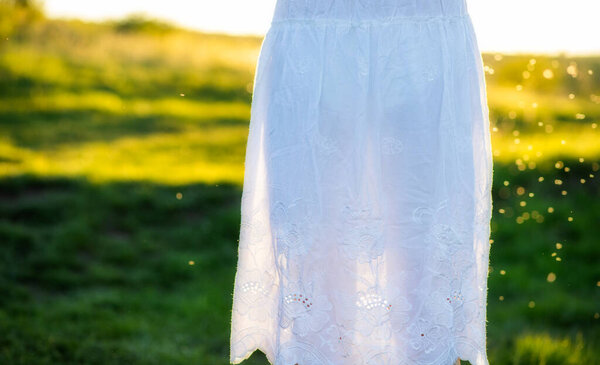 White dress from the back in sunset light woman outdoors
