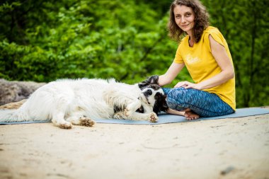 Köpeğiyle yaz doğasının tadını çıkaran bir kadın.