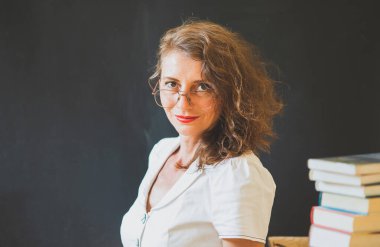 Okulun konsept öğretmenine karatahtanın önünde