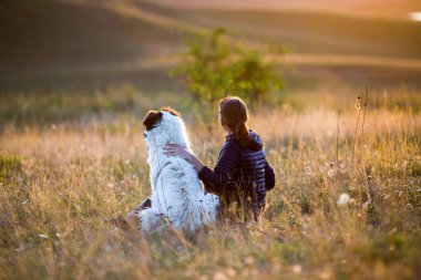 Sonbahar manzarasında köpekli bir kadın oynuyor