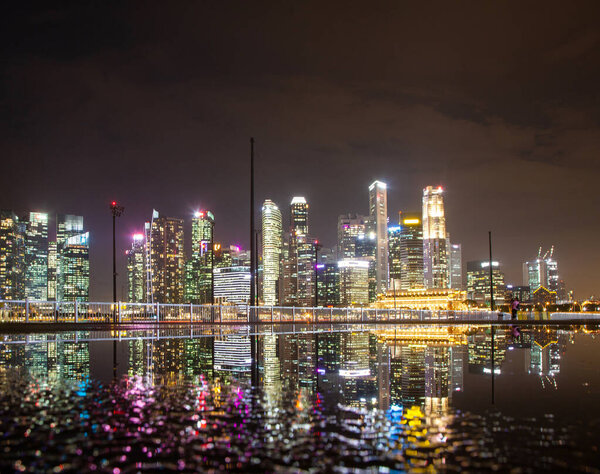 SINGAPORE, SINGAPORE - MARCH 2019: Skyline of Singapore Marina Bay at night with Marina Bay sands, Art Science museum , skyscrapers and tourist boats